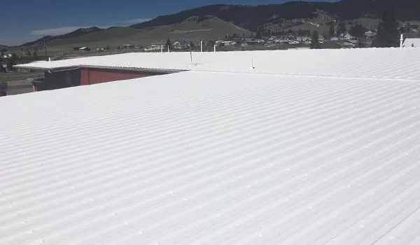 Spray foam roofing installation showing seamless waterproof barrier application on commercial building