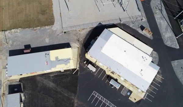 Metal roof restoration project by Falcon Roofing Systems - before and after commercial roof coating application in Georgia